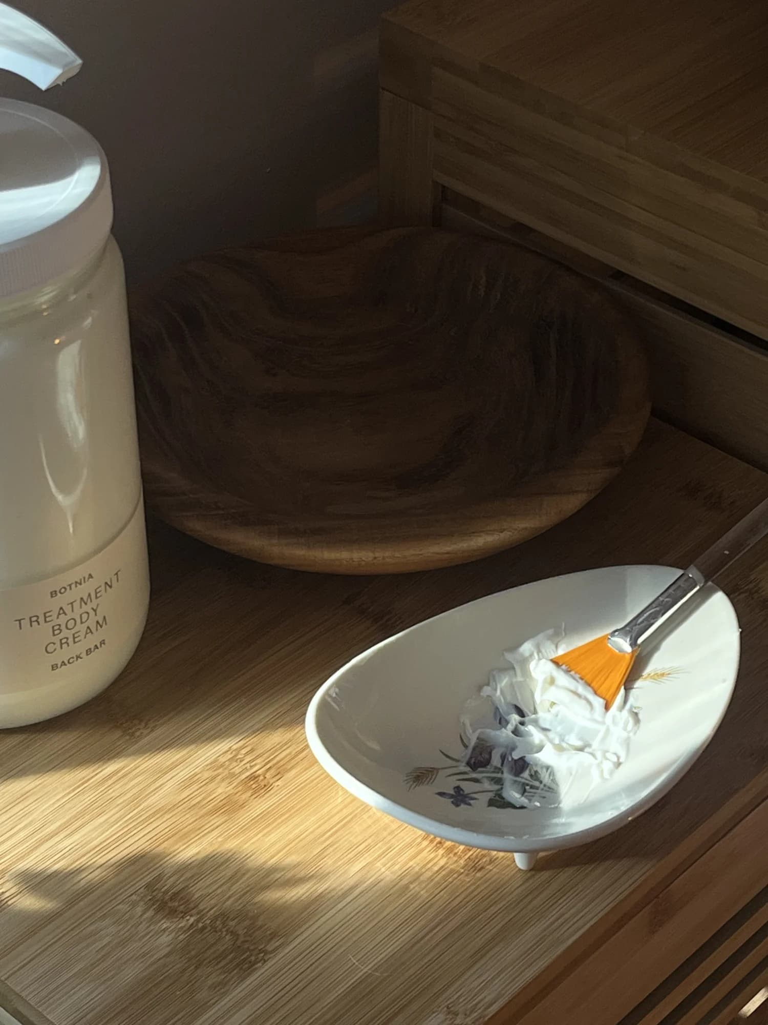 Botnia mask preparation — warm light, botanical ingredients
