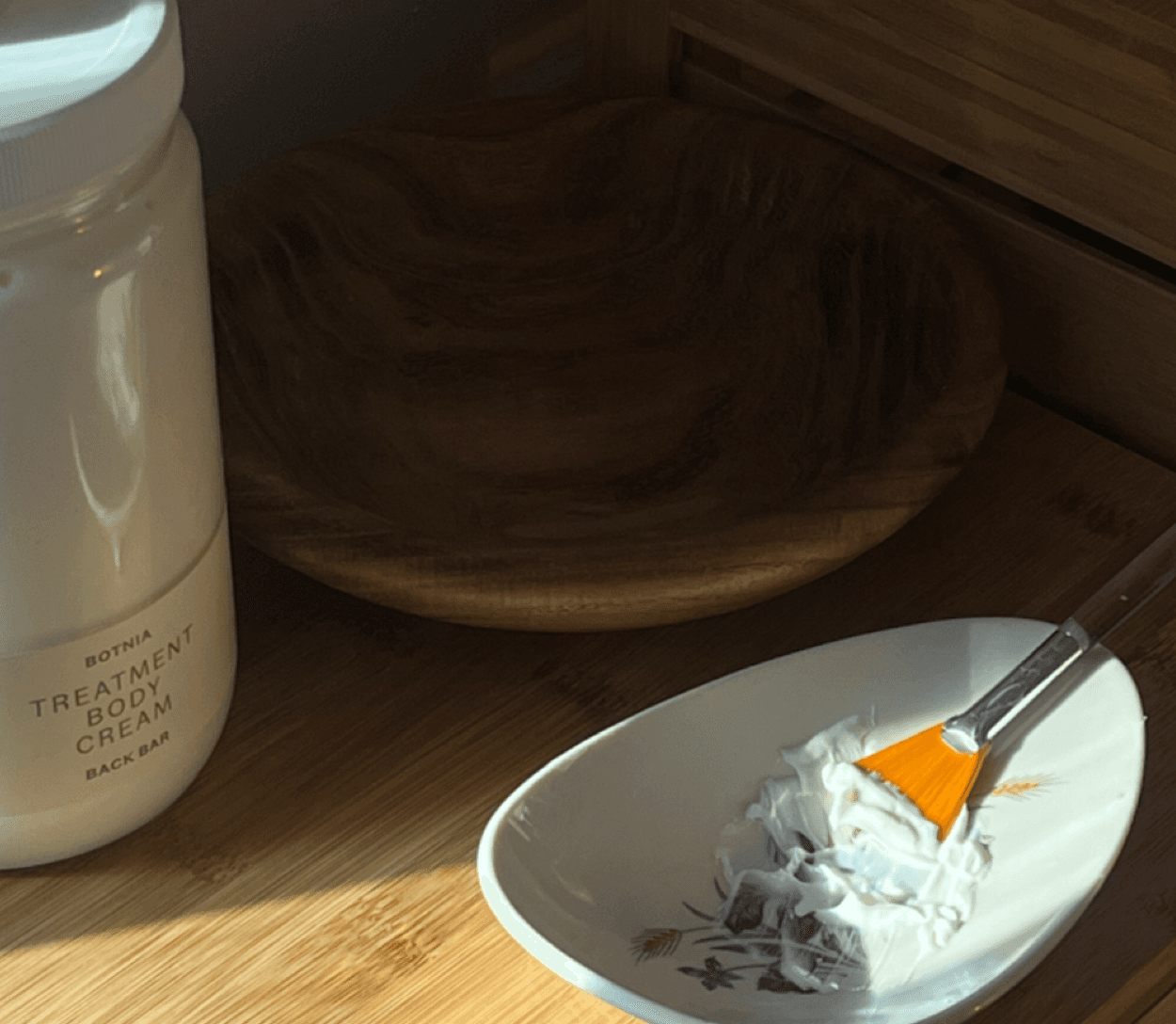 Botnia mask preparation — warm light, botanical ingredients